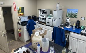 A lab technician working on a computer in a lab